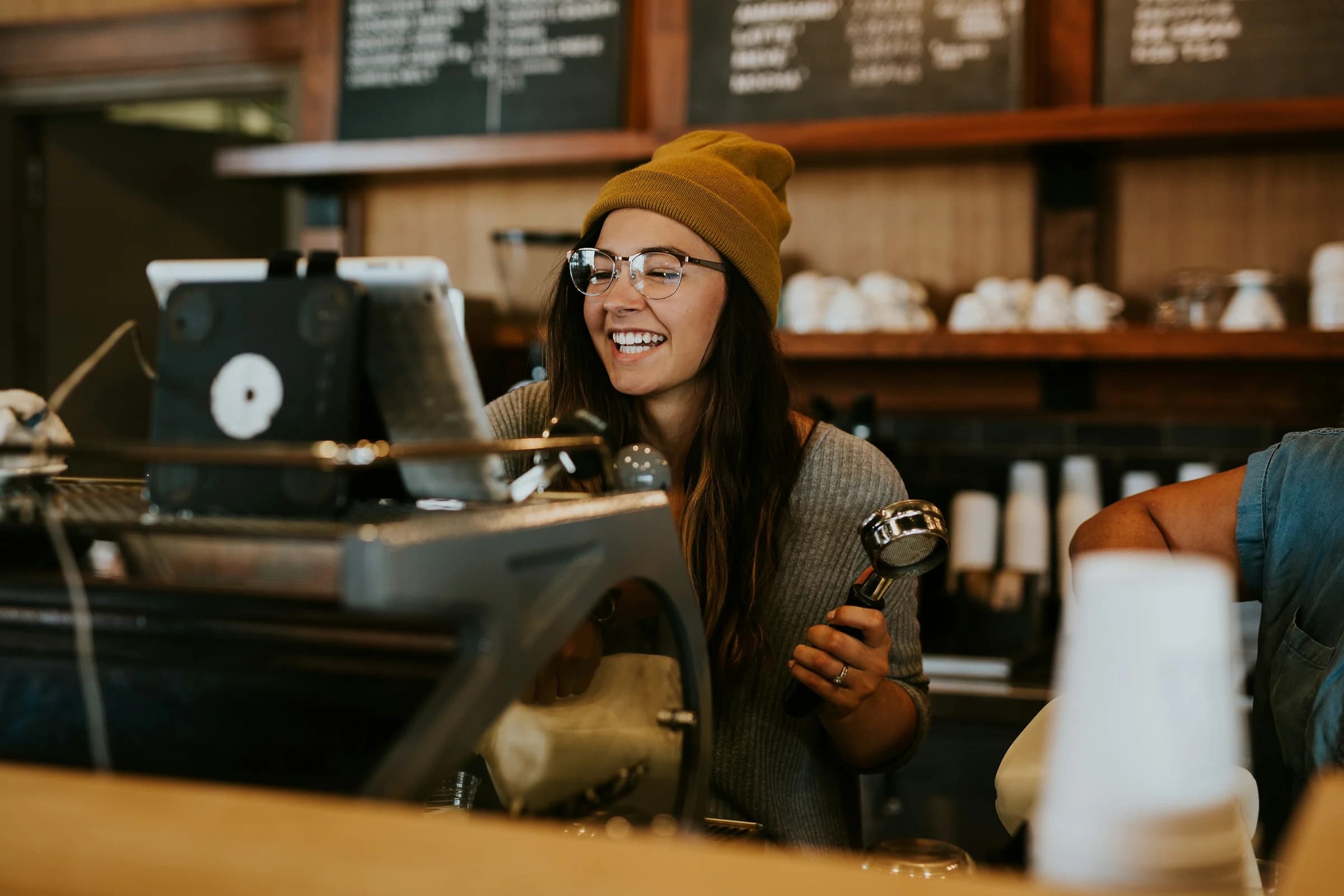 Barista sonriendo detrás de la barra